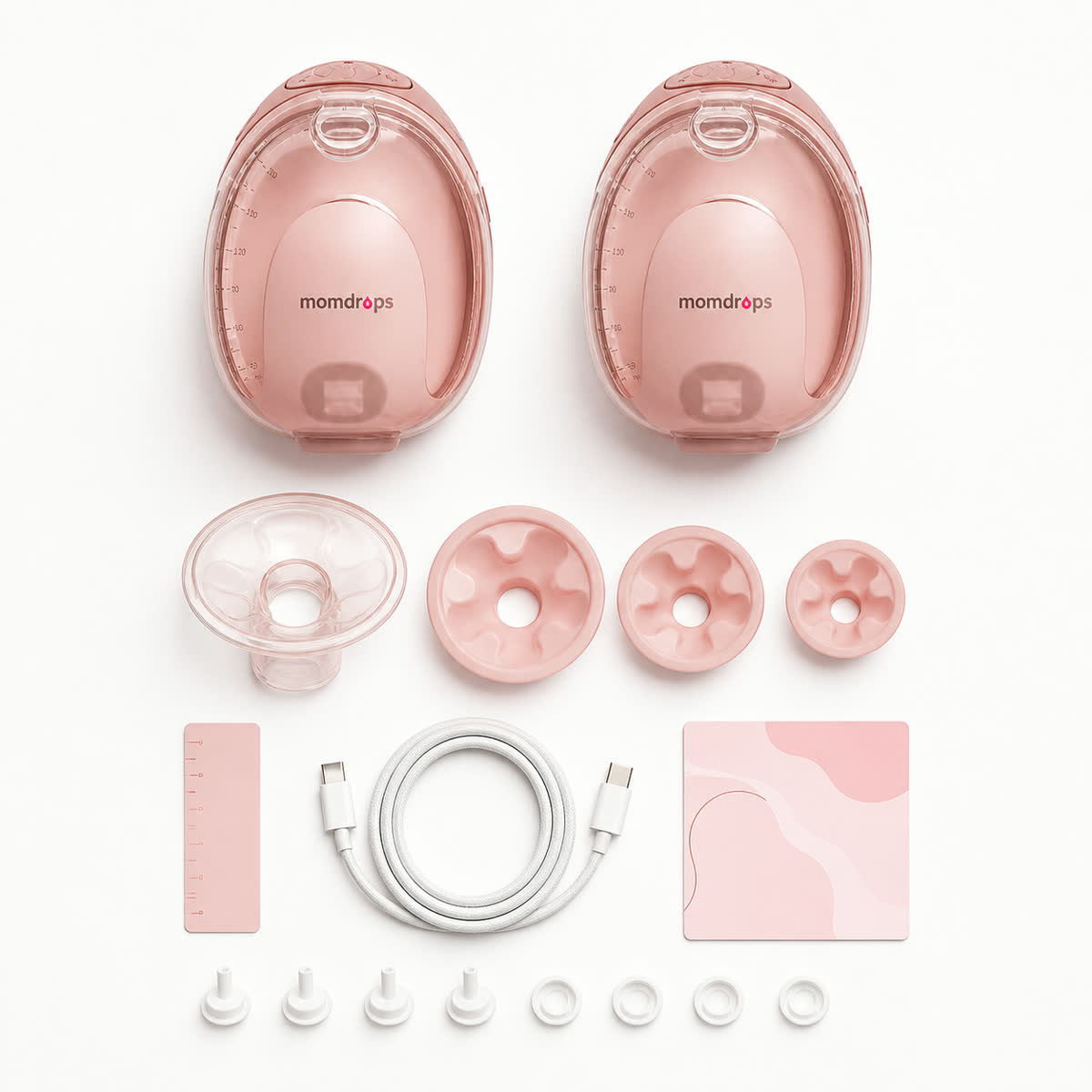 Everything included with Momdrops, laid out: two pumps, flange inserts, cable and spare parts
